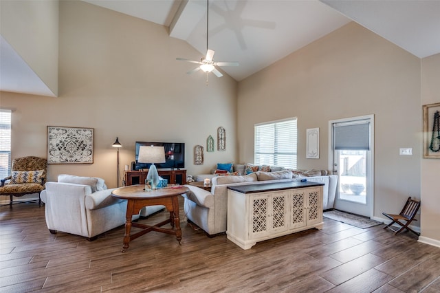 living room with ceiling fan and high vaulted ceiling