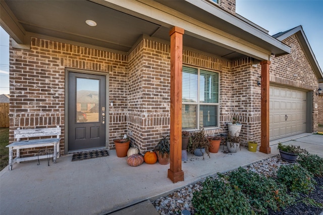 view of exterior entry featuring a garage