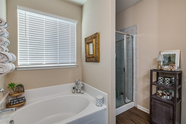 bathroom featuring separate shower and tub and hardwood / wood-style flooring