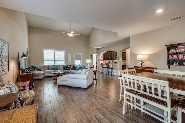 living room with ceiling fan, high vaulted ceiling, and hardwood / wood-style flooring