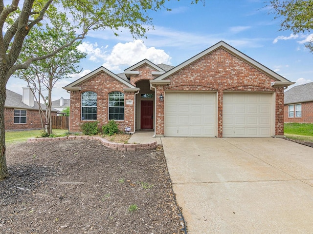 single story home with fence, concrete driveway, brick siding, and an attached garage