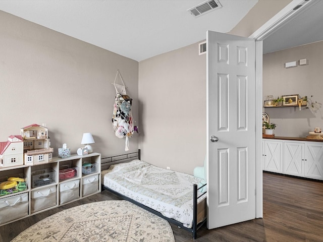 bedroom with dark wood-type flooring