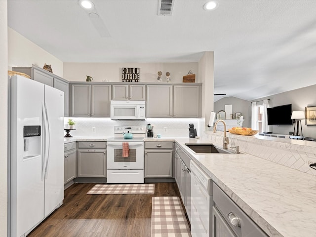 kitchen with sink, white appliances, decorative backsplash, and gray cabinets