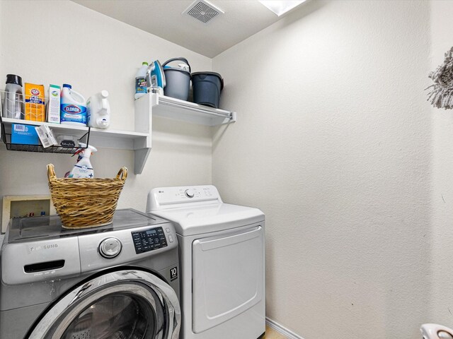 laundry room with visible vents, independent washer and dryer, and laundry area
