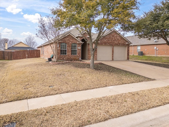 single story home with a garage, a front yard, and central AC