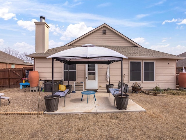 back of property featuring a patio area and a gazebo