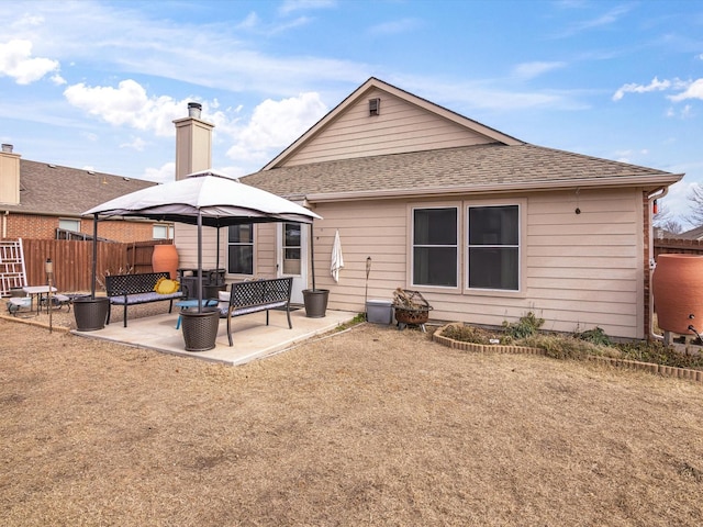 back of property featuring a patio area and a gazebo