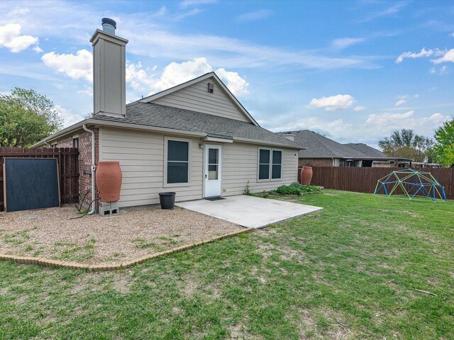 back of house featuring a patio area, a chimney, a fenced backyard, a lawn, and roof with shingles
