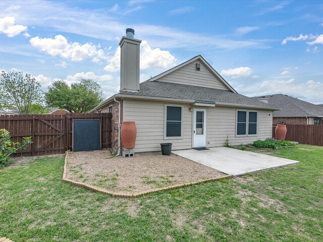 rear view of property featuring a patio, a lawn, a fenced backyard, and a gate