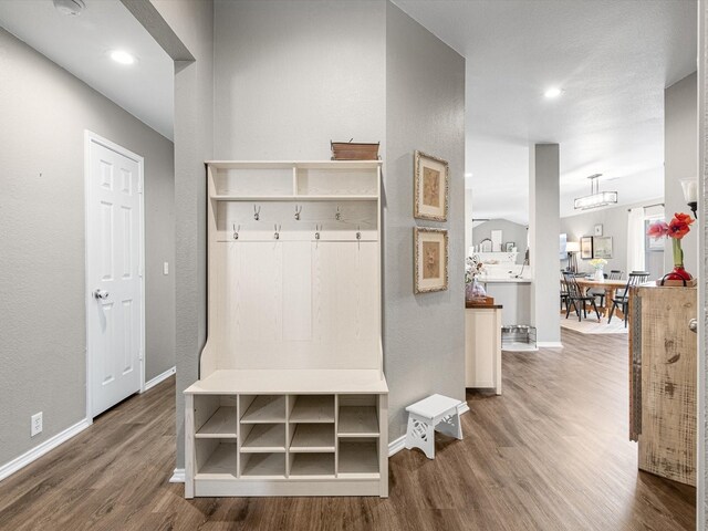 mudroom featuring recessed lighting, wood finished floors, and baseboards
