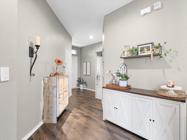 hall with recessed lighting, dark wood-style floors, and baseboards
