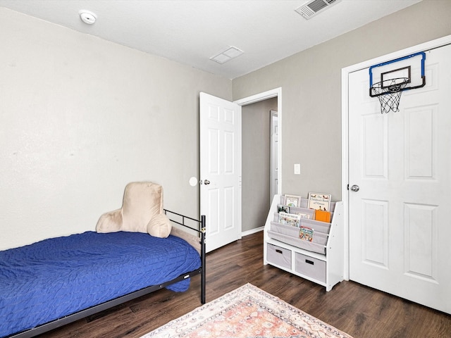 bedroom with dark hardwood / wood-style flooring