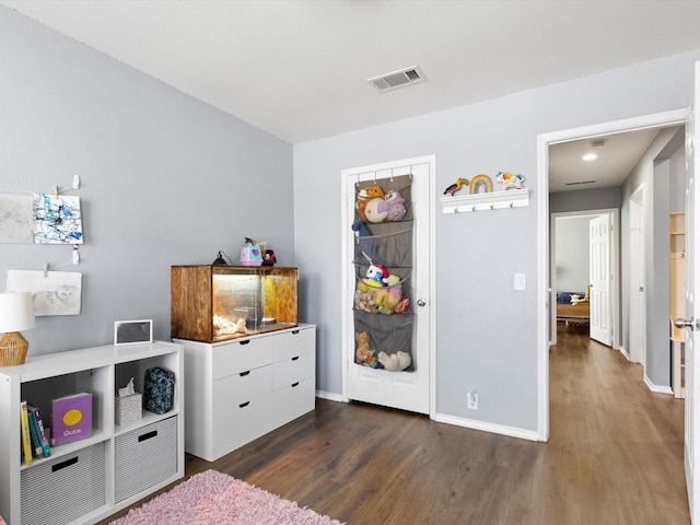 playroom with dark wood-type flooring