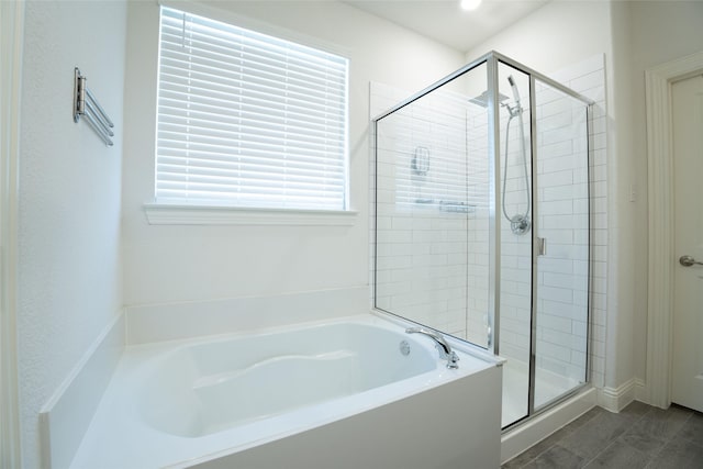 bathroom with a healthy amount of sunlight and separate shower and tub