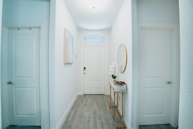 hallway with light hardwood / wood-style floors