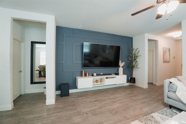 living room with ceiling fan and hardwood / wood-style flooring