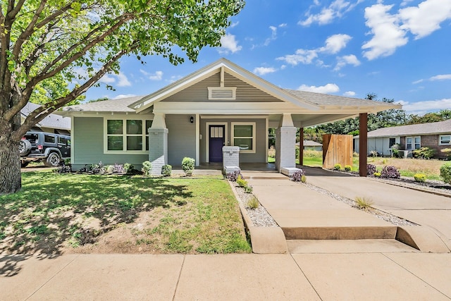 view of front of home with a front yard and a porch