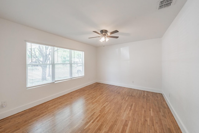 spare room featuring ceiling fan and light hardwood / wood-style flooring