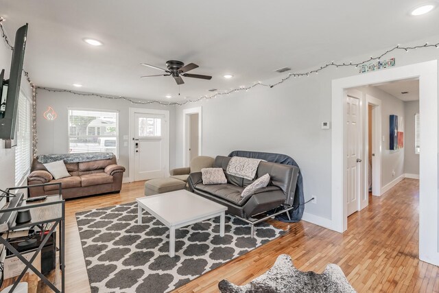 living room featuring ceiling fan and hardwood / wood-style flooring