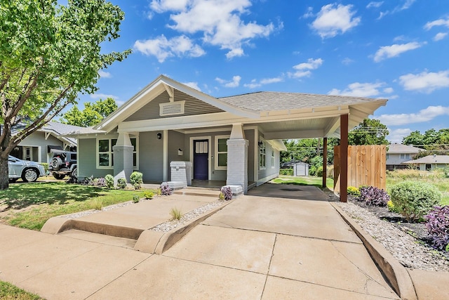 view of front of house featuring a front lawn and a storage unit