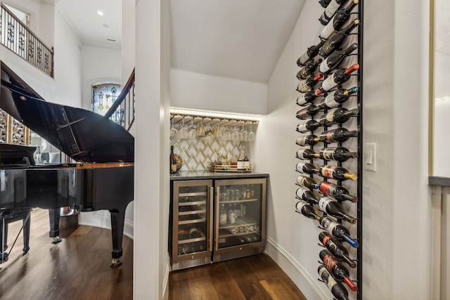 wine area with dark wood-type flooring and wine cooler