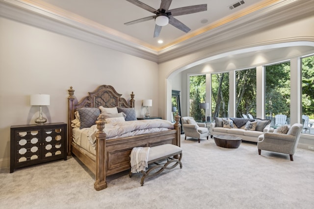 carpeted bedroom with ceiling fan and ornamental molding