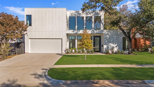 modern home with a front lawn and a garage