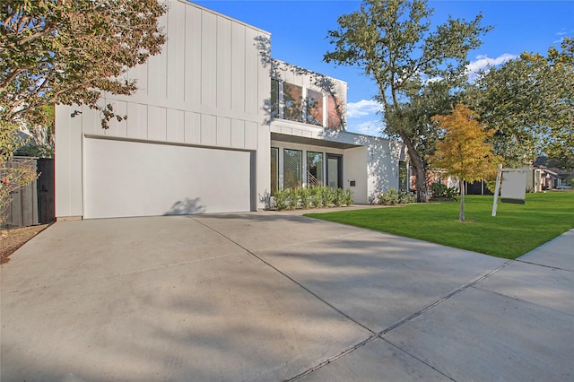 view of front of property featuring a garage and a front yard