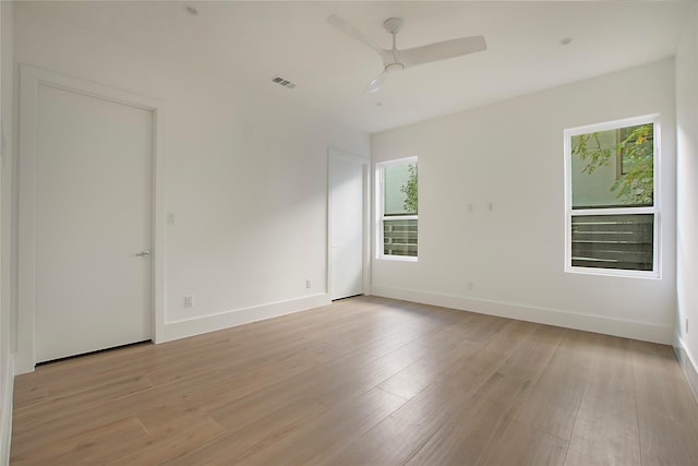 spare room featuring ceiling fan and light hardwood / wood-style flooring