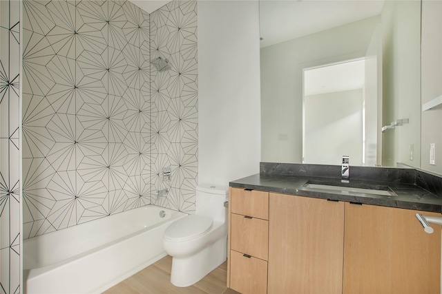 full bathroom with toilet, vanity, wood-type flooring, and tiled shower / bath combo