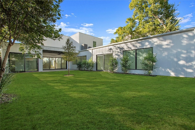 rear view of house with a yard