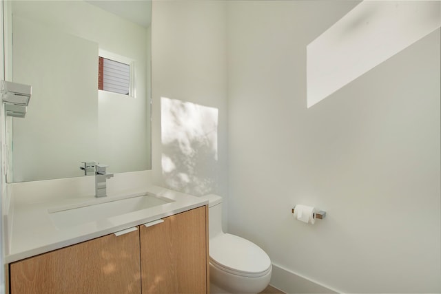 bathroom with toilet and vanity