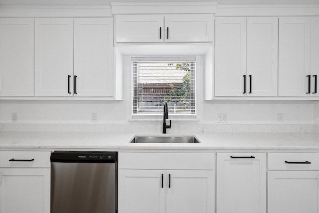 kitchen featuring stainless steel dishwasher, white cabinets, and sink