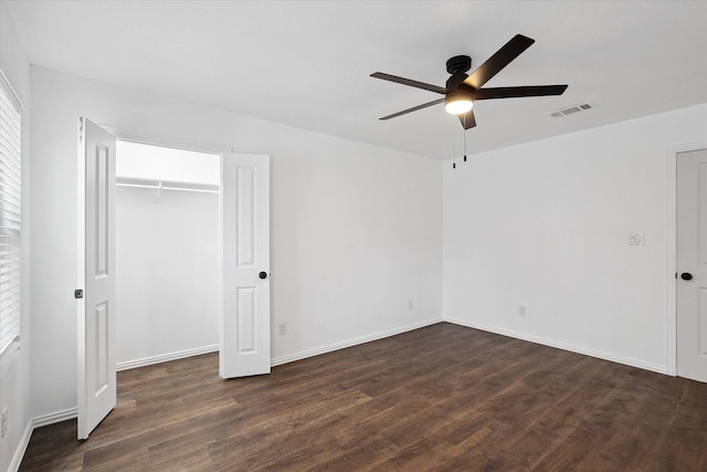 unfurnished bedroom with ceiling fan, dark hardwood / wood-style flooring, and a closet