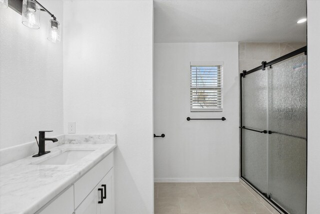 bathroom featuring an enclosed shower and vanity