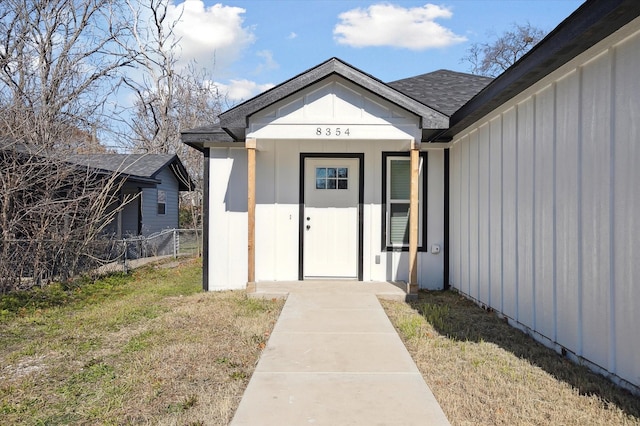 view of exterior entry with a lawn