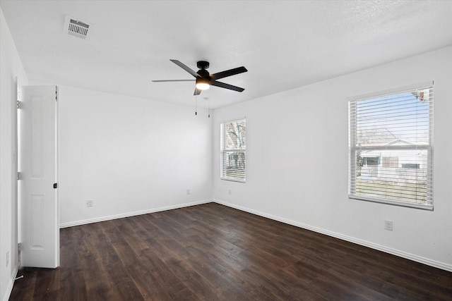 unfurnished room featuring ceiling fan and dark wood-type flooring