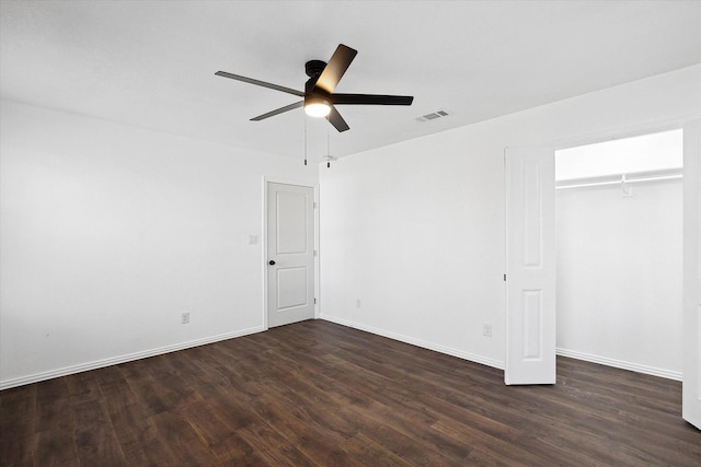 unfurnished bedroom featuring dark wood-type flooring, ceiling fan, and a closet