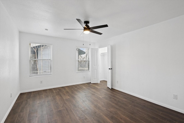 unfurnished room featuring ceiling fan and dark hardwood / wood-style floors