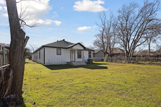 view of front of house with a front yard and central AC