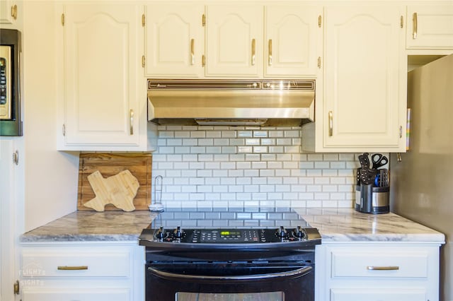 kitchen with white cabinets, ventilation hood, black stove, and decorative backsplash