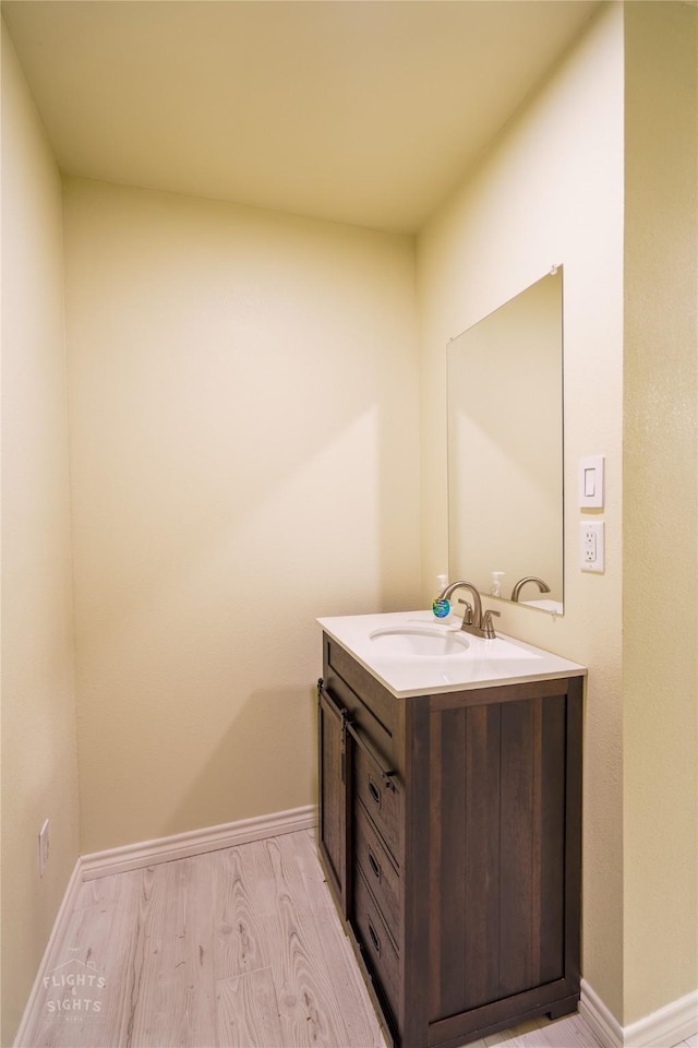 bathroom with hardwood / wood-style floors and vanity