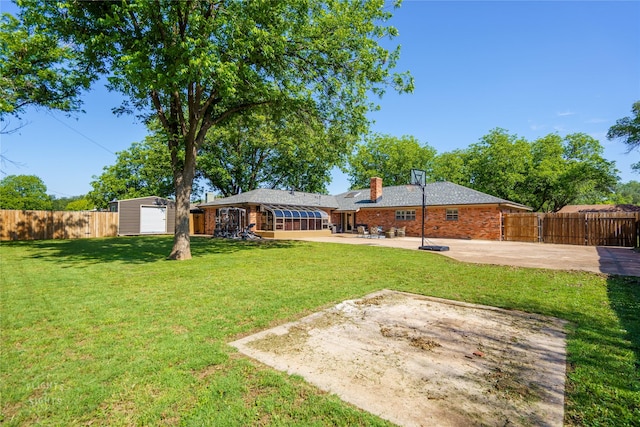 view of yard with a patio area and a shed