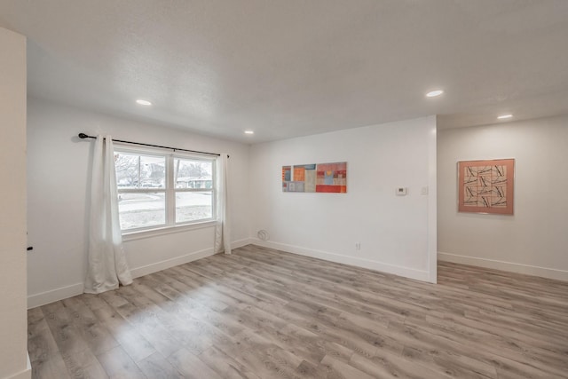 spare room featuring light wood-type flooring