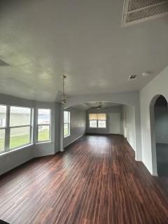 unfurnished living room with dark wood-type flooring