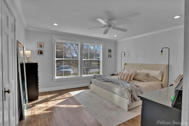 bedroom with ceiling fan, hardwood / wood-style floors, and crown molding