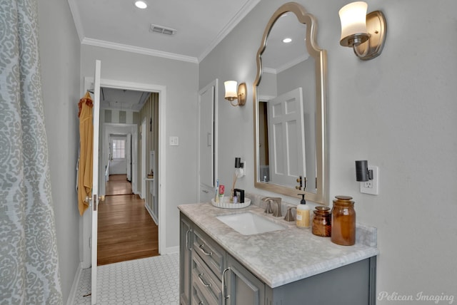 bathroom with vanity, tile patterned floors, and crown molding