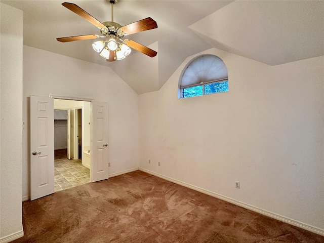 carpeted spare room with ceiling fan and lofted ceiling