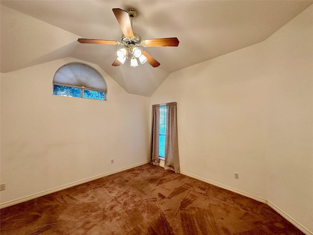 unfurnished room featuring carpet floors, vaulted ceiling, and ceiling fan