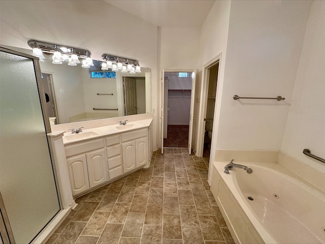 full bathroom featuring toilet, vanity, and independent shower and bath